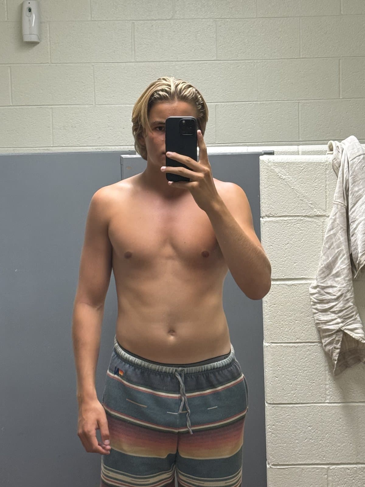 Before: mirror selfie with a softer, less defined torso