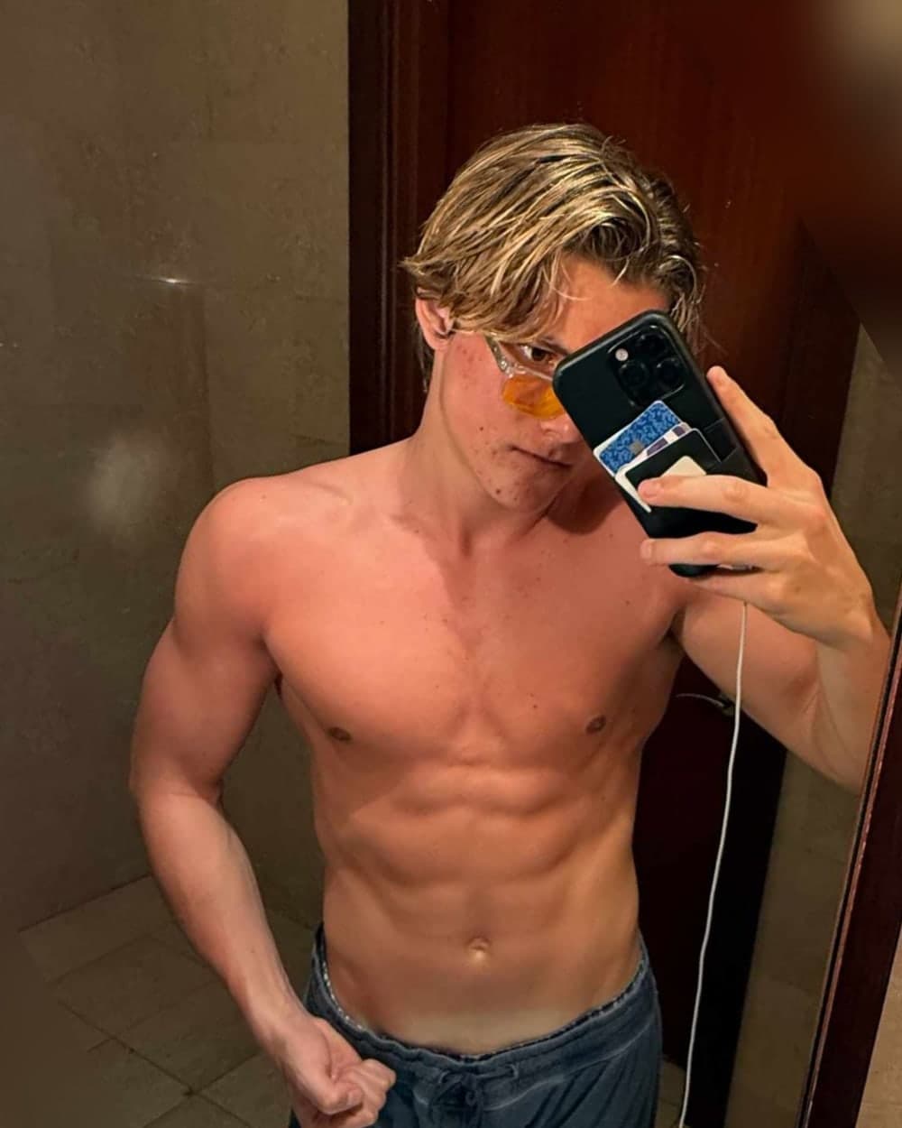 After: mirror selfie with a lean, defined torso and visible abs